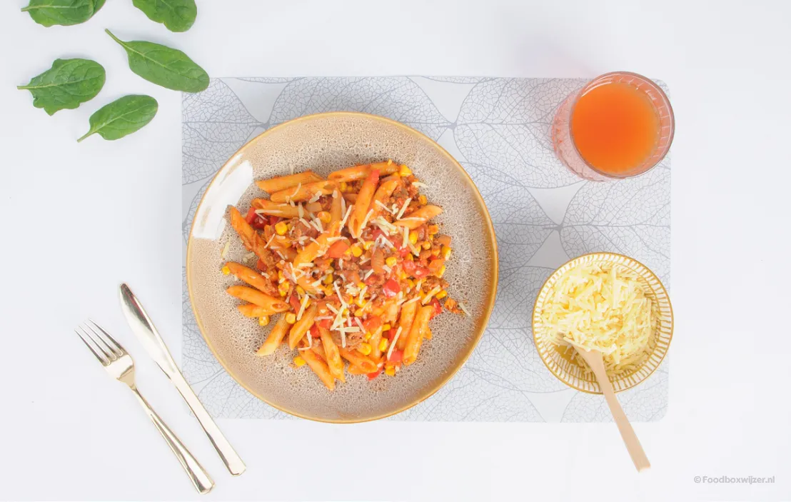 Op onze tafel staat een kindvriendelijke gerecht van hellofresh met pasta, mais en tomatensaus