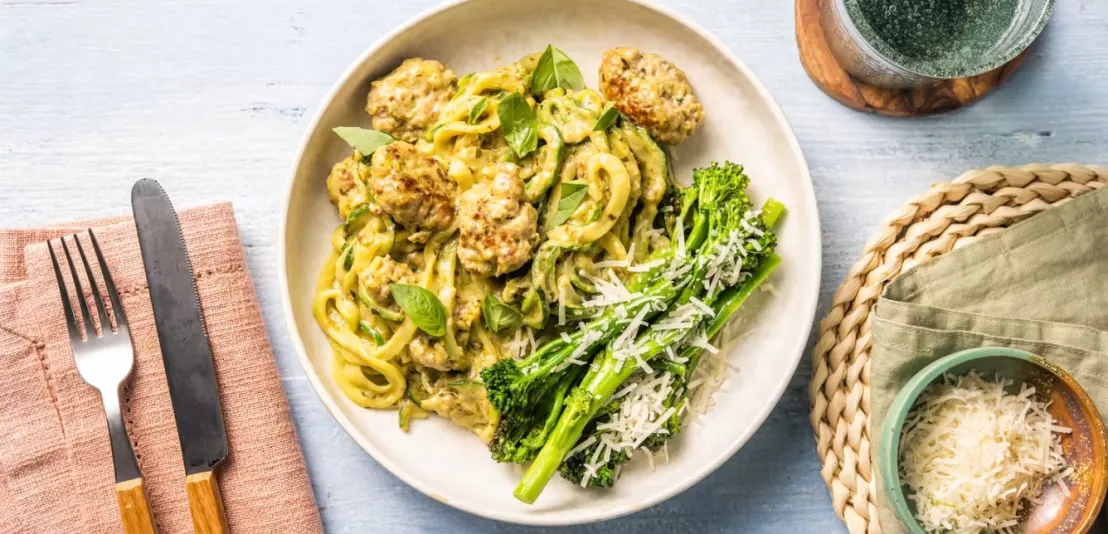 Op een bord geserveerd een ketogeen gerecht met kipgehakt en courgetti in romige saus
