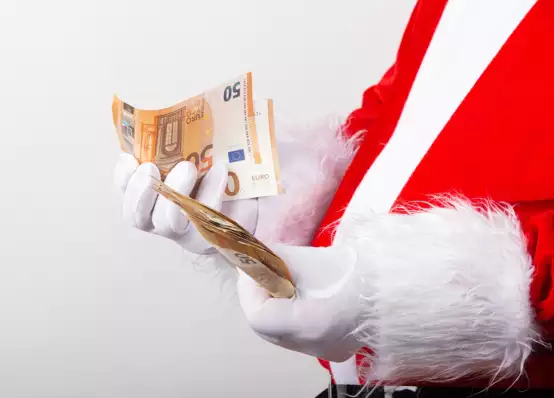Kerstman telt het geld; wat ga je uitgeven voor het kerstdiner?
